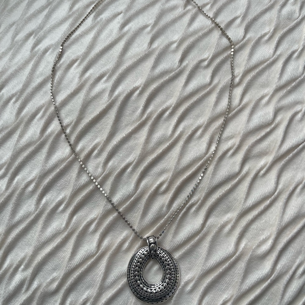 Necklace with large pendant.